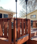 Tiki Torch Deck Or Fence Mount Kit Black For Three Quarter Inch And One Inch Poles on wooden deck railing, installed setup