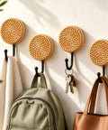 Four Pack Slick Boho Wall Hooks Decorative Wide Opening Coat Rack For Towels Backpacks And Purses With Rock Solid Screw Mount Heavy Duty Home Storage For Keys Jewelry And Everyday Carry on a wall with bags and towels.
