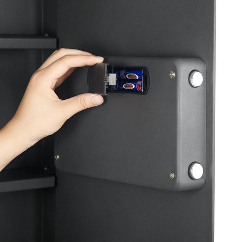 Person inserting batteries in Hidden In Wall Safe with Electronic Keypad and Two Manual Override Keys for secure storage