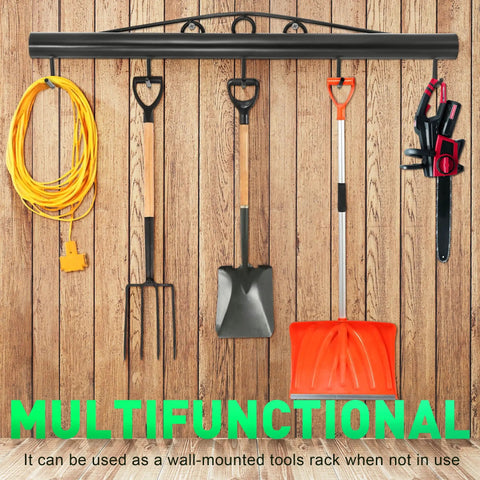 Wall-mounted tool rack holding garden tools, extension cord, and saw against wooden background.
