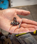 Hand holding 10 Pack Handle Screws, Rivets, Bolts, And Fasteners With Hex Key For DIY Knife Making And Fixed Blade Repairs.