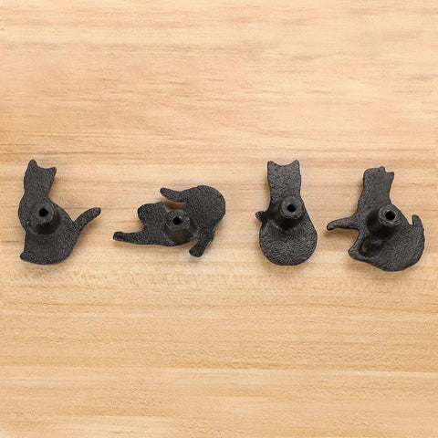 Four Pose Cat Cast Iron Drawer Knobs For Dresser Cabinet Wardrobe And Bookcase Vintage Kitty Pull Handles That Add Fun Charm And Character To Furniture And Home Decor black cast iron cat knobs shown on wood