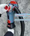 Side view of Beast 5 Inch Concrete Grinder With Dust Extraction Shroud 1500W Diamond Cup Wheel held by operator on concrete wall.