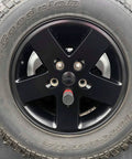 Spare Tire And Wheel Lock For 2018 Up Jeep Wrangler JL installed on a black alloy wheel, stainless pin visible