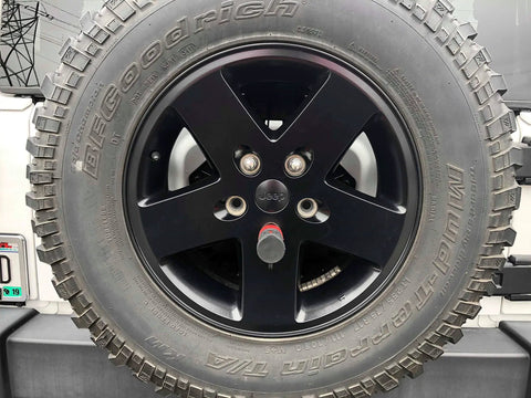 Spare Tire And Wheel Lock For 2018 Up Jeep Wrangler JL installed on a black alloy wheel, stainless pin visible