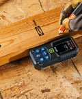 Person using Blaze Green Beam Laser Distance Measure With 165 Foot Range And One Sixteenth Inch Accuracy Backlit Color Display Battery Included