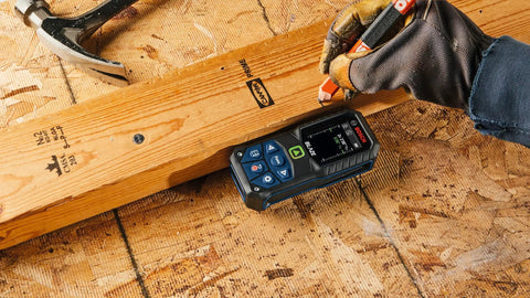 Person using Blaze Green Beam Laser Distance Measure With 165 Foot Range And One Sixteenth Inch Accuracy Backlit Color Display Battery Included