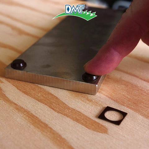 Finger showing Dia Sharp Diamond Knife Sharpener Bench Stone's non-slip base detail on wooden surface