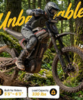 Adult Off Road Electric Dirt Bike Featuring A Badass 16800W Peak Motor And Massive 72V 50Ah Battery For Serious Torque Beast Mode Riding Along With Dual Shock Suspension And Grippy Wide Tires in a forest.