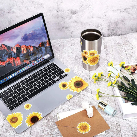 Laptop and mug with sunflower decals from 72 Pieces Sunflower Wall Sticker Set Peel And Stick 3D Removable Waterproof Decals For Bedroom Kitchen Bathroom Living Room Bright Sunny Wall Decor For Kids And Home