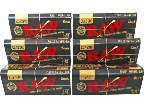 Six packs of Classic Black One And A Quarter Size Natural Unrefined Ultra Thin 79mm Rolling Papers displayed in a stack.