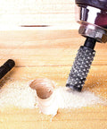 NordWolf 10-piece rotary burr set with 1/4" hex shank; drill-mounted knurled burr carving wood, spare burr resting on the wood.