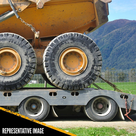 Flatbed trailer with construction equipment secured by 4 Pack Lever Style Chain Binders for 5/16 Inch Grade 70 and 3/8 Inch Grade 43 Chains