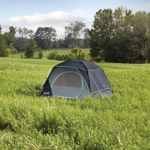 Skydome Camping Tent With Five Minute Setup Weatherproof 2, 4, 6, And 8 Person Shelter in grassy field under blue sky