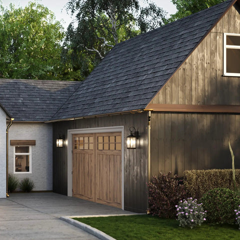 Two Light Outdoor Wall Lantern in Antique Bronze with Clear Beveled Glass on rustic house exterior by garage.