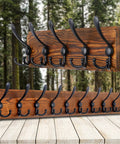 Rustic Wall Mounted Coat Rack With 16 Inch Stud Spacing Pine Real Wood Plank 5 Triple Hooks against forest backdrop