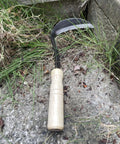 Left Handed Garden Weeder Tool With Sharp Edge Sickle Hoe For Precision Weeding And Grass Cutting In Tight Spaces on stone
