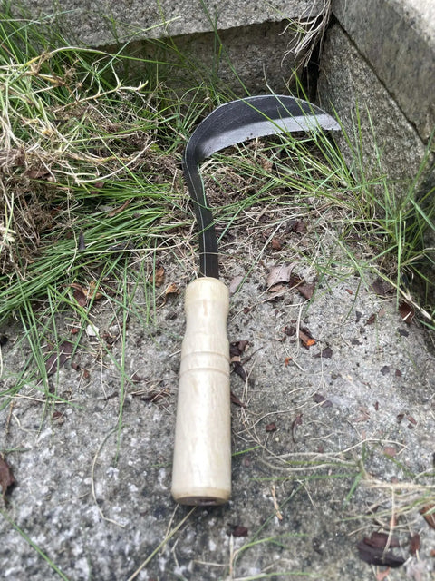 Left Handed Garden Weeder Tool With Sharp Edge Sickle Hoe For Precision Weeding And Grass Cutting In Tight Spaces on stone