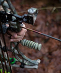 Archery setup featuring S-Coil Bow Stabilizer 4.5 Inch NAVCOM Vibration Dampening in use, camo finish, close-up view.