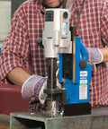 Hougen HMD904 115-Volt magnetic drill; blue and gray metal tool drilling steel.