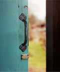 Rustic Gate Handle 9 Inch Cast Iron Barn Door Handle installed on blue door, black finish, heavy duty metal pull.