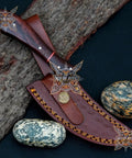 Beast Damascus Steel Skinner Knife with wood handle on leather sheath, ideal for hunting and camping.
