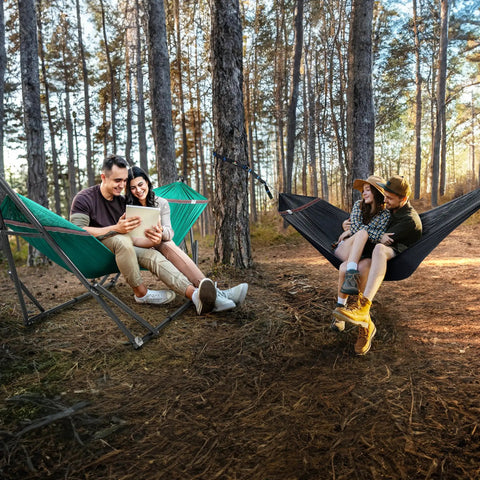 Two people relaxing in green and black Combo Hammocks With Stand For Outdoor And Indoor Use, Heavy Duty 600 Lbs Capacity, 2 Person Set