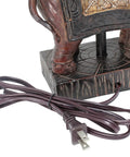 Close-up of brown resin base with plug for Festive Elephant Table Lamp In Brown With Gold Accent Resin Base And Brown Fabric Shade