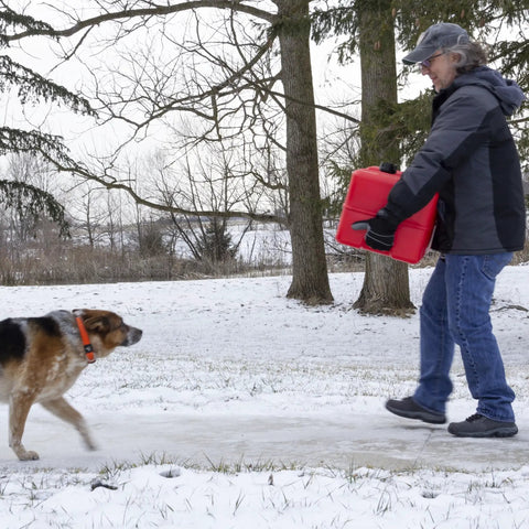 Person carrying Portable 12 Gallon Marine Gas Can With Built In Fuel Gauge And Pick Up Cap 2 Way Vented Cap Reliable Winter Use