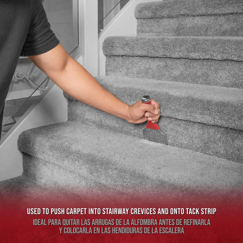 Hand using Extra Wide Carpet Tucker And Stair Tool In Chrome Plated Steel For 4 Inch Tack Strips on grey stair carpet.