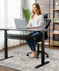 Woman sitting on 36x48 Inch Office Chair Mat For Hardwood And Tile Floors Under Desk, Grippy Non Slip Vinyl Floor Protector With Rubber Backing in home office.