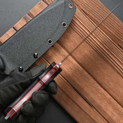 Rugged AUS 10 Fixed Blade Knife With Carbon Fiber Handle shown with sheath on wooden background