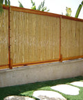 Natural Bamboo Fence Roll Panel 0.75 Inch Thick 6 Foot High By 8 Foot Long for outdoor privacy on a patio wall.