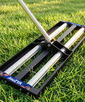 Pro-Grade Heavy-Duty Lawn Leveling Rake With Aluminum Roller Base And Stainless Steel Build on grass surface