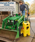 Person using Duramax 14 Gallon Wheeled Diesel Fuel Transfer Tank with Spout Pump Yellow next to green tractor