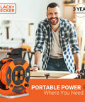 75 Ft Retractable Extension Cord Reel With 4 Outlets in workshop setting, Black+Decker branding visible.