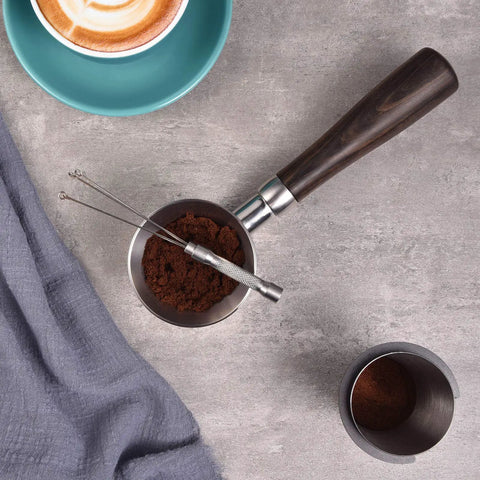 Espresso Coffee Stirrer Stainless Steel Mini Whisk with knurled handle on coffee grounds in a portafilter basket on table