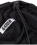 Close-up of black dustproof Lycra cover for DJ gear featuring adjustable shock cord and Gator logo, fits 22x22x6 inches