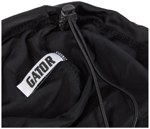 Close-up of black dustproof Lycra cover for DJ gear featuring adjustable shock cord and Gator logo, fits 22x22x6 inches