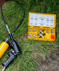 LockNLube grease fitting multi-tool kit in yellow case; opened to reveal assorted metal fittings and large grease gun