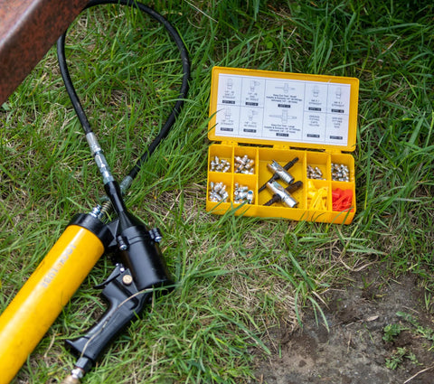 LockNLube Grease Fitting Multi-Tool (Small) in yellow case with assorted fittings
