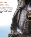 Close-up of flowing water on Outdoor Rainforest Waterfall Tree Trunk Floor Fountain With Led Lights, Tiered Garden Decor.