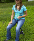 Woman seated on Portable Folding Camping Stool With PackSeat Design Lightweight Yet Durable Ultra Compact Seat outdoors