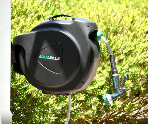 Retractable Garden Hose Reel With 100 Ft 5/8 Inch Hose Wall Mounted 180 Degree Swivel Bracket on a sunny day