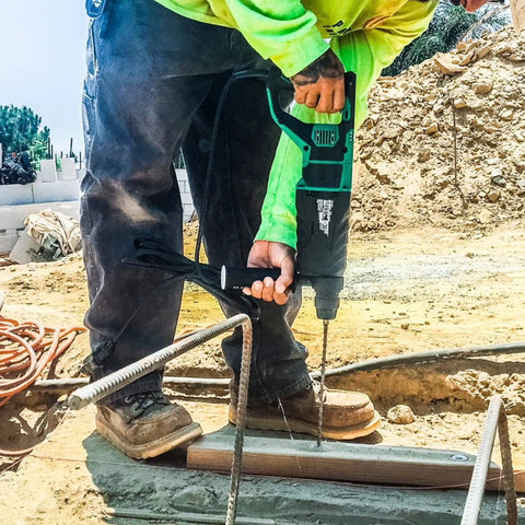 Person using Powerhouse Heavy Duty SDS Plus Rotary Hammer Drill One And One Eighth Inch 3 Mode at construction site.