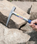 Rock Pick Hammer 13 Oz Field Geology Tool with milled face and shock reduction grip being used on rocks.