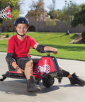 Child riding Crazy Cart Sport 24V Electric Drifting Go Kart with Variable Speed Pedal, outdoor setting, helmet on for safety.