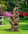 Outdoor 5 Tier Cascading Water Fountain With Realistic Tree Trunk Look, Resin Imitation Wood, LED Accent Lights in garden.