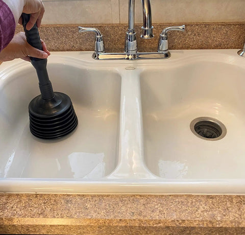 Person using Heavy Duty Toilet Plunger MP1003 with Patented Automatic Air Relief Valve in kitchen sink