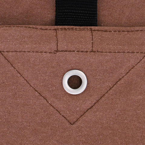 Close-up of the Rugged Workhorse 18 Oz Canvas Tarp showing rustproof grommet and stitching, industrial grade cloth in brown